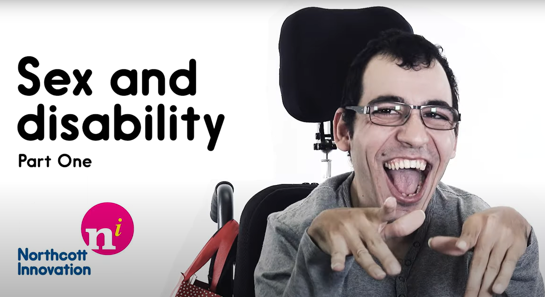 Cover Image for Sex and Disability Video featuring a masperson wearing glasses and in a chair smiling widely at the camera with their hands in front of them. There is tect on the image that reads: Sex and Disability Part One